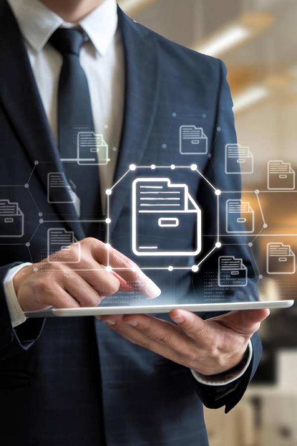 IT Projects 10 Person in a suit holding a tablet with a security shield icon